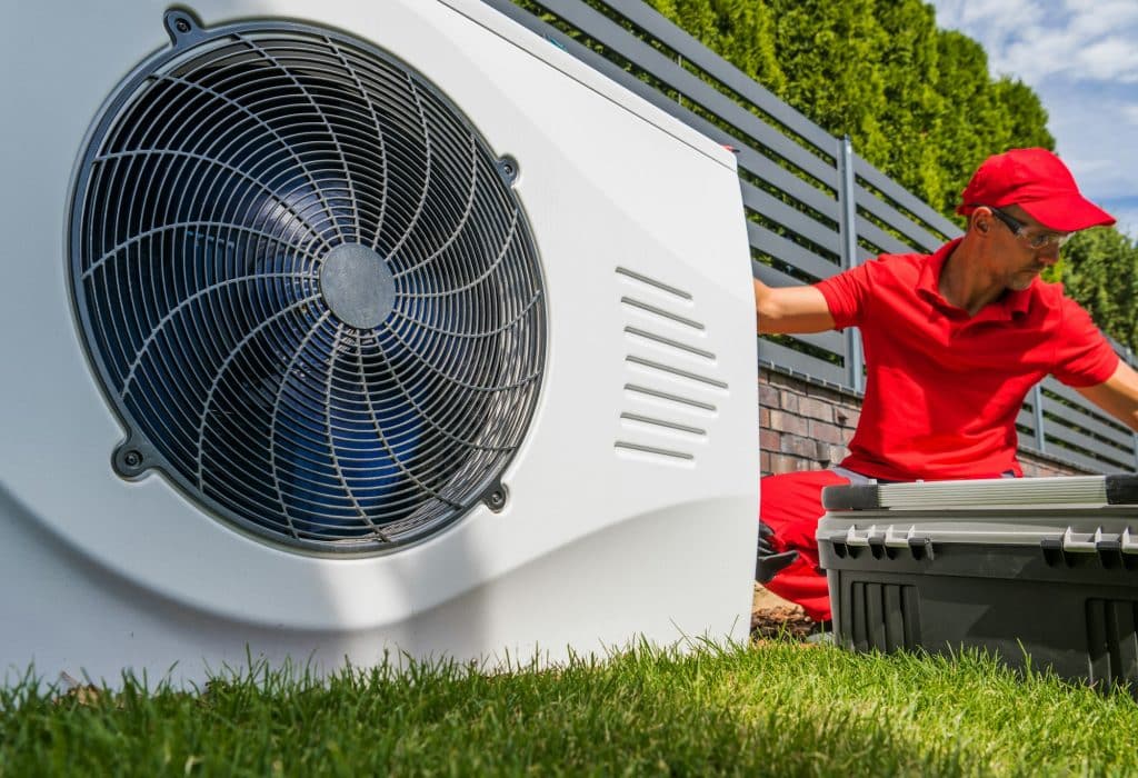 Trusted heating and air conditioning hvac in king & pierce county | Residential Furnace System Technician at Work Professional HVAC Worker Installing Swimming Pool Heat Pump
